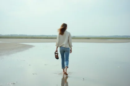 Femme se promenant pieds nus sur les vasières de la baie de Somme au printemps près de Saint-Valery-sur-Somme